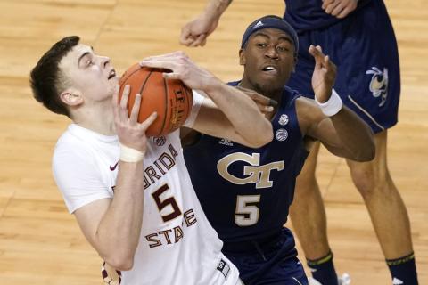 Georgia Tech forward Moses Wright (5) defends as Florida State center Balsa Koprivica (5) heads to the basket during the ACC Tournament championship game on Saturday in Greensboro, N.C. (GERRY BROOME/Associated Press)