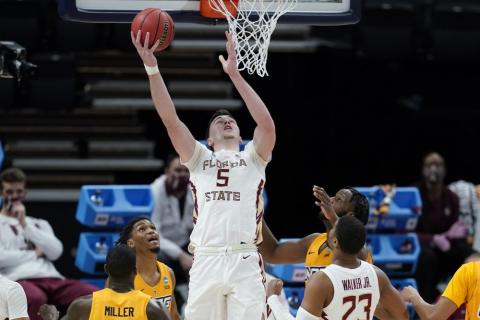Florida State's Balsa Koprivica (5) puts back a rebound for a basket during the second half of a first-round game against UNC-Greensboro in the NCAA Tournament at Banker's Life Fieldhouse on Saturday in Indianapolis. Florida State defeated UNC-Greensboro 64-54. (DARRON CUMMINGS/Associated Press)