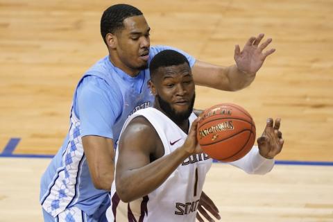 Florida State forward RaiQuan Gray (1) looks to pass the ball as North Carolina forward Garrison Brooks, left, defends during the ACC Tournament semifinals on Friday in Greensboro, N.C. (GERRY BROOME/Associated Press)