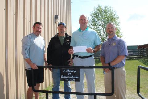 Andy Bennett (from left), Westside Elementary School physical education teacher; stands with Darryl Thomas, Columbia High School welding teacher; Dennis Dotson, Westside Elementary School principal; and Trey Hosford, Columbia High School principal; during a brief presentation Wednesday morning where the Grayson Martin Memorial Welding Scholarship was established at the Columbia High School welding lab. Martin was killed in a wreck weeks earlier. (TONY BRITT/Lake City Reporter)