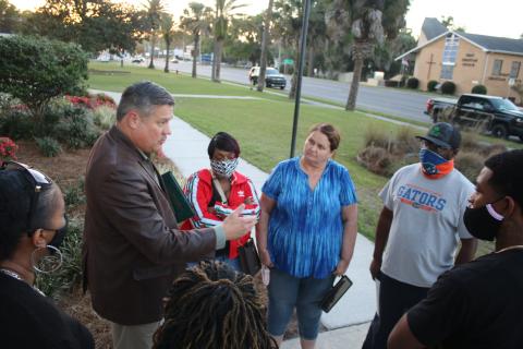 Sheriff Mark Hunter (left) discusses internet cafes with a group of supporters Thursday evening. (TONY BRITT/Lake City Reporter)