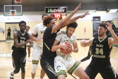 FGC forward Brandon Farmer gets double teamed by PHSC forwards Warren McLymont (left) and Edgard Enriquez (right) during Saturday's FCSAA Region 8 Division II Championship at the Howard Center. (JORDAN KROEGER/Lake City Reporter)