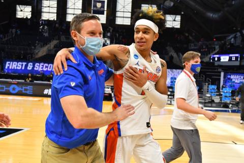Florida head coach Mike White embraces Tre Mann after they defeated Virginia Tech in the first round of the NCAA Tournament at Hinkle Fieldhouse on March 19 in Indianapolis, Ind. (BRETT WILHELM/Pool Photo via AP)