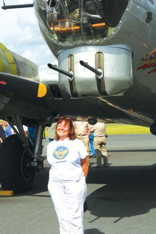 Catherine Feyerabend of Clearwater stands underneath the ‘Aluminum Overcast’ on Sunday. She said flying in a B-17 like her father had been on her bucket list. (JAMIE WACHTER/Lake City Reporter)