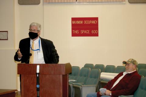 Daniel Sweat (left) speaks to the Lake City Council in a December meeting as Paul Dyal looks on. (FILE)
