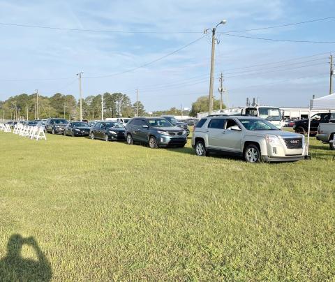 Vehicles line up Thursday morning at the Florida Gateway Fairgrounds parking lot to receive the covid-19 vaccine. (COURTESY)