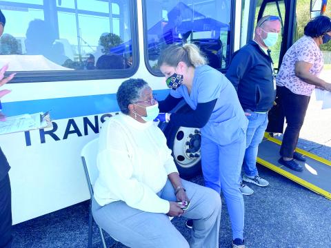 Blondell Johnson receives a vaccination shot Thursday after receiving a ride from the Richardson Community Center to the vaccination site. (COURTESY)