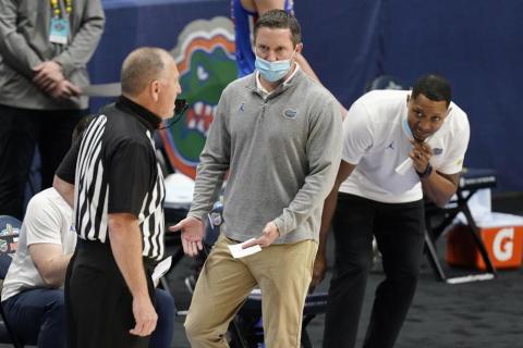 Florida head coach Mike White talks with an official in the first half of a game against Tennessee in the Southeastern Conference Tournament March 12 in Nashville, Tenn. (MARK HUMPHREY/Associated Press)