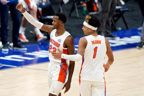 Florida's Scottie Lewis (23) and Tre Mann (1) leave the court after the Gators' win against Vanderbilt during the SEC Tournament last month. (MARK HUMPHREY/Orlando Sentinel/TNS)
