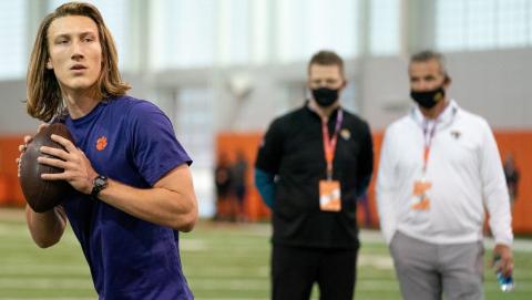Clemson Tigers quarterback Trevor Lawrence works out as Jacksonville Jaguars head coach Urban Meyer (right) looks on during Clemson's Pro Day on Feb 12 in Clemson, S.C. (DAVID PLATT/Handout Photo via USA TODAY Sports via TNS)