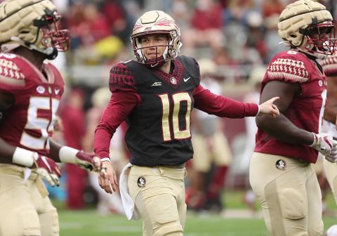 FSU quarterbacks Tate Rodemaker (18) and Gino English (15) watch quarterback McKenzie Milton (10) throw during the FSU Garnet & Gold Spring Game at Doak Campbell Stadium on April 10 in Tallahassee. (STEPHEN M. DOWELL/Orlando Sentinel/TNS)