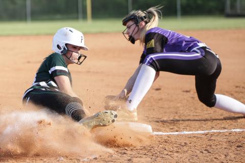 Suwannee pitcher Karis Smith beats the tag from Columbia third baseman Anissa Penniman to slide safely into third base during Tuesday night’s game. (BRENT KUYKENDALL/Lake City Reporter)