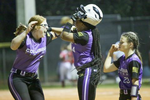 Columbia’s Hailey Bowmer (left) and Karis Jernigan celebrate after the Tigers’ 10-9 win over Bradford on Friday night. (BRENT KUYKENDALL/Lake City Reporter)