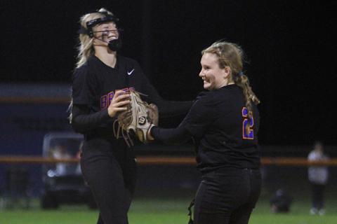 Branford third baseman Madison Sikes celebrates with pitcher Laila Arnold after an out against Fort White on Thursday night. (PAUL BUCHANAN/Special to the Reporter)