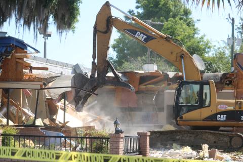 An unidentified employee from Dale’s Excavation uses an excavator to demolish the Burger King building at the intersection of West Duval Street and Southwest Main Boulevard Tuesday morning. Plans are for a new Burger King restaurant to be at the site within 30 days. (TONY BRITT/Lake City Reporter)