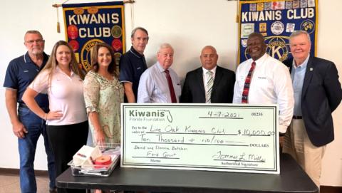 Kiwanis Club personnel Hardy Tillman (from left), Kelly Renfroe, Monja Slater (Lt. Govenor), Danny Hales, Tom Weller, Ryan Peters (President), Tommy Mills (Kiwanis Florida Foundation President) and Jim Wylie (Kiwanis Foundation Past President) pose with the ceremonial $10,000 check. (COURTESY)