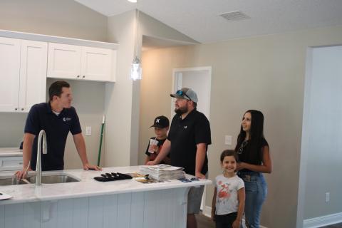 Bradley Franks (from left), of Bradley Franks Construction, talks to Stuart Morris, Jon Morris, Ashley Morris and Nora Morris on Sunday as the Morris family looks through a Bradley Franks home featured in the 2021 Parade of Homes. (TONY BRITT/Lake City Reporter)