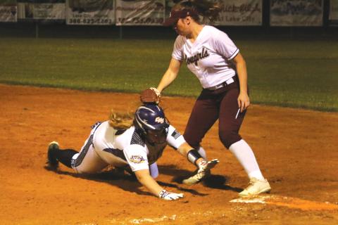 Columbia’s Alexis Blair is tagged out trying to slide back to first base against Madison County on Tuesday night. (MORGAN MCMULLEN/Lake City Reporter)