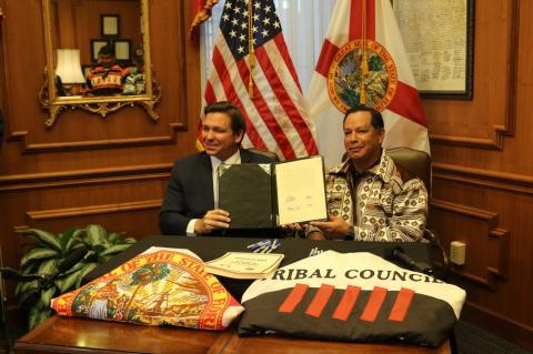 Gov. Ron DeSantis and Marcellus Osceola Jr., chairman of the Seminole Tribe of Florida, pose for a photo April 23 after signing a gambling compact. (MCT)