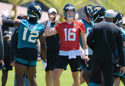 Jaguars quarterback Trevor Lawrence (16) talks with teammates during drills at rookie minicamp. (BOB SELF/Florida Times-Union/TNS)
