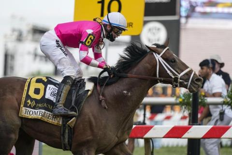 Flavien Prat atop Rombauer reacts as he crosses the finish line to win the Preakness Stakes horse race at Pimlico Race Course on Saturday in Baltimore. (JULIO CORTEZ/Associated Press)