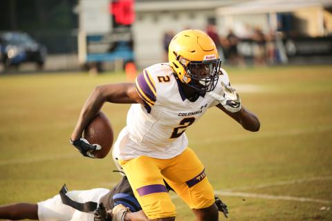 Columbia receiver Marcus Peterson races past a Bartram Trail defender after a catch Friday night in the Tigers’ spring game. (BRENT KUYKENDALL/Lake City Reporter)