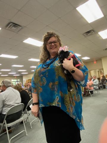 Renee Williams, a model for the Lake City-Columbia County Humane Society inaugural fashion show, holds a puppy as she models clothing and accessories from the agency’s thrift store. (COURTESY)