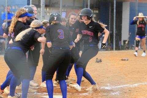 Branford third baseman Madyson Sikes strolls into home plate and celebrates with her teammates after hitting one of her two home runs against Hilliard during Thursday’s Region 3-1A semifinal. (PAUL BUCHANAN/Special to the Reporter)