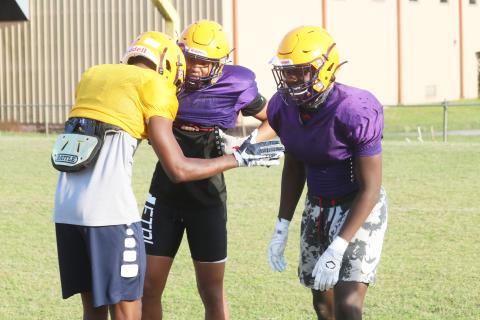 Columbia cornerback Amare Ferrell (middle) and linebacker Jaden Robinson (right) joke around with receiver Marcus Peterson after a play during practice on April 29. (JORDAN KROEGER/Lake City Reporter)