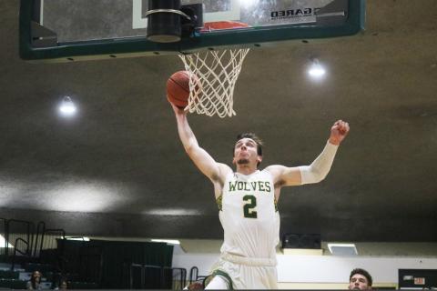 FGC forward Layton Veon rises on a fast break for a dunk against Pasco-Hernando State during the Region 8 championship game on March 27. Veon committed to Coastal Georgia on Thursday after finishing up his two years with the Timberwolves. (JORDAN KROEGER/Lake City Reporter)