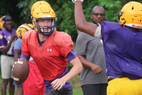 Columbia quarterback Kade Jackson scrambles away from pressure during Wednesday’s practice. (JORDAN KROEGER/Lake City Reporter)