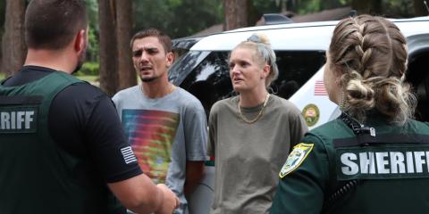 Deputies with the Columbia County Sheriff’s Office talk with Kirk Lanham and Lauryn Jones on Tuesday morning after the two were seen on surveillance cameras burglarizing a pool house on NW Streamside Court. (COURTESY COLUMBIA COUNTY SHERIFF’S OFFICE)