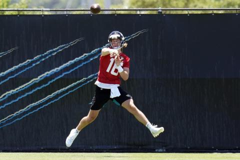 Jacksonville Jaguars quarterback Trevor Lawrence (16) throws a pass during rookie minicamp on Saturday in Jacksonville. (JOHN RAOUX/Associated Press)
