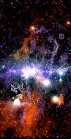 This false-color X-ray and radio frequency image made available by NASA on Friday, May 28, 2021 shows threads of superheated gas and magnetic fields at the center of the Milky Way galaxy. X-rays detected by the NASA’s Chandra X-ray Observatory are in orange, green, blue and purple, and radio data from the MeerKAT radio telescope in South Africa are shown in lilac and gray. The plane of the galaxy is horizontal, in the center of this vertical image. (NASA/CXC/UMass/Q.D. Wang)