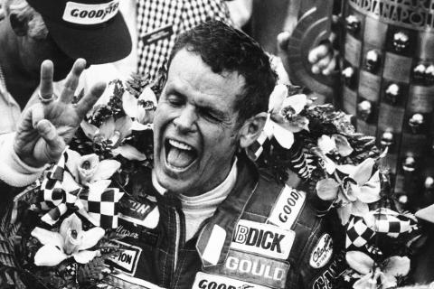 Bobby Unser holds three fingers aloft after winning his third Indianapolis 500 on May 24, 1981, in Indianapolis, Ind. Unser died of natural causes at his home on Sunday in Albuquerque, New Mexico. He was 87. (AP FILE PHOTO)