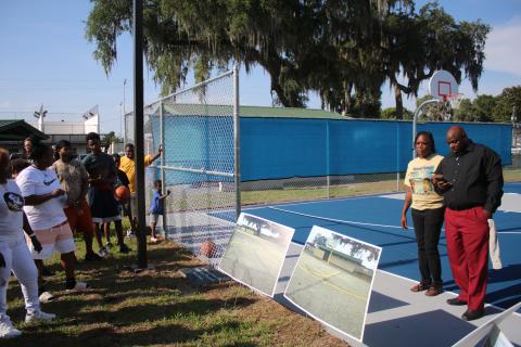 Angela Harrison and Preston Owens (far right), mother and uncle to the late Alphonso Harrison, address the crowd at the Youngs Park basketball courts Thursday afternoon. (TONY BRITT/Lake City Reporter)