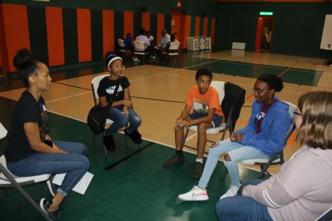 Tanya Parker (far left) leads students in a discussion about the Tulsa Massacre during a Northstar Family Resource Center Juneteenth program Thursday. (TONY BRITT/Lake City Reporter)