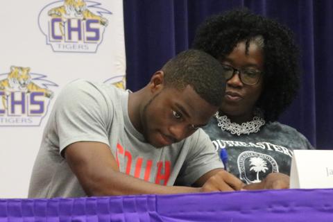 Columbia track & field athlete James Williamson signs his letter of intent with Southeastern University on Wednesday. (JORDAN KROEGER/Lake City Reporter)