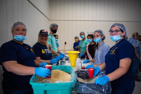 A group of volunteers from Columbia County helps in packaging meals during the recent Meals Of Hope event. (COURTESY)