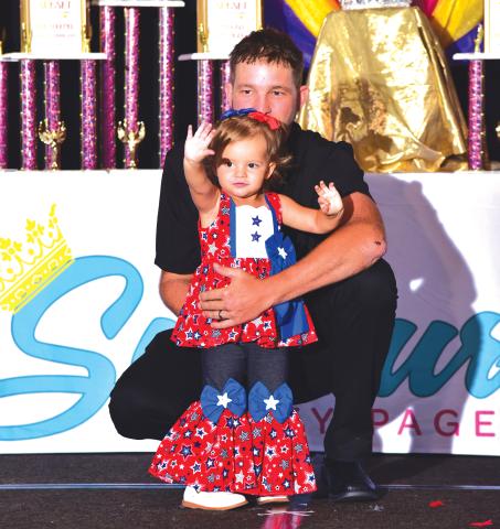 Julia Miller shows off her red, white and blue outfit alongside her father, Jevon, at the Florida Sunburst Beauty Pageant competition. (COURTESY)