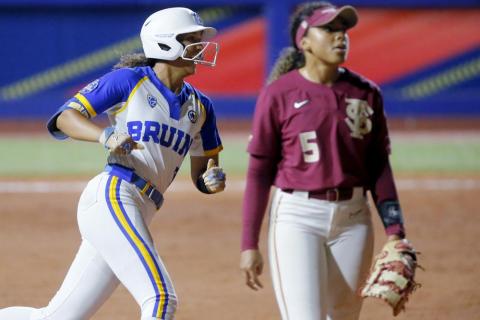 UCLA's Maya Brady (7) smiles as she runs past Florida Sate's Elizabeth Mason (5) after hitting a home run against Florida State in the sixth inning of Thursday's Women's College World Series game in Oklahoma City. (BRYAN TERRY/The Oklahoman via AP)