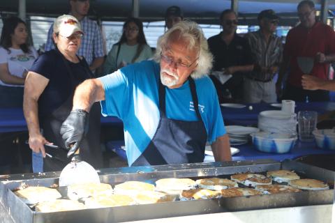 Jim Bezaire flips a batch of blueberry pancakes Saturday morning. (MORGAN MCMULLEN/Lake City Reporter)