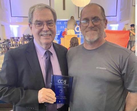 John Cole III (right) poses with his father after John Cole Jr. won the 2021 CCS Teacher of the Year award. (COURTESY)