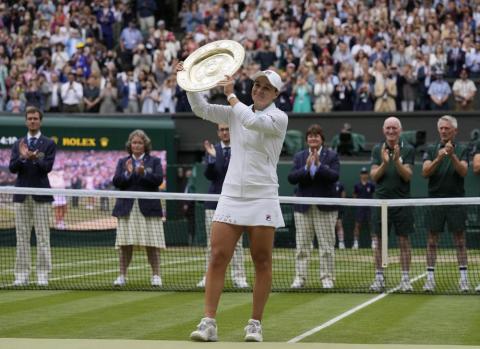 Ashleigh Barty poses with the trophy for the media after defeating Karolina Pliskova to win the Wimbledon women's singles final on Saturday in London. (KIRSTY WIGGLESWORTH/Associated Press)