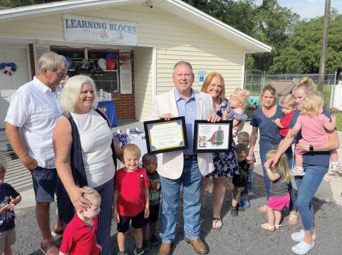 Rep. Chuck Brannan is pictured with parents and their children who benefited from hearing and screening tests June 25 at a Macclenny daycare. (COURTESY)