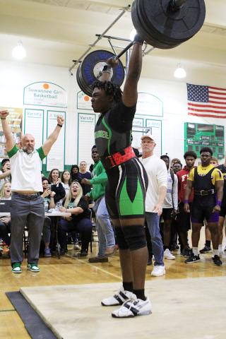 SHS weightlifting coach Dan Marsee (left) raises his fists in celebration after Austin Smith completes a rep. (PAUL BUCHANON/Lake City Reporter)