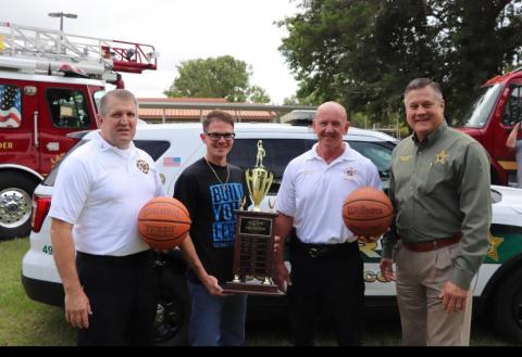 Lt. Dwight Boozer (from left) of the Lake City Fire Department, stands with Lake City Middle School Principal Robert Cooper, Columbia County Fire Rescue Chief Jeff Crawford and Columbia County Sheriff Mark Hunter. (COURTESY)