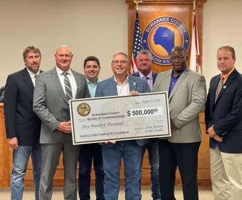 Rep. Chuck Brannan and Hunter Peeler, a legislative aide for Sen. Jennifer Bradley, presented the Suwannee County Board of County Commissioners with a $500,000 state appropriations check Tuesday. Pictured are County Commissioner Travis Land (from left), County Commissioner Don Hale, Peeler, Brannan, County Commissioner Franklin White, County Commissioner Clyde Fleming and County Commissioner Len Stapleton. (COURTESY)