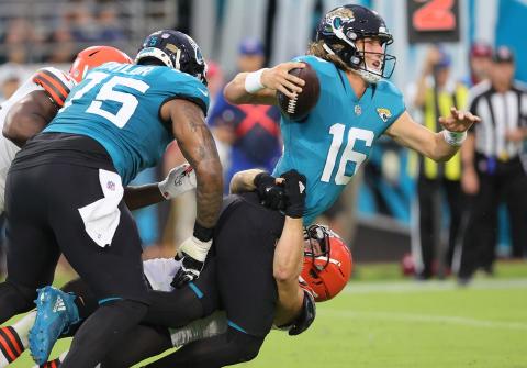 Cleveland Browns defensive end Porter Gustin (bottom) is able to get by the block of Jacksonville Jaguars offensive tackle Jawaan Taylor (L) to get a sack on Jaguars quarterback Trevor Lawrence at TIAA Bank Field on Saturday in Jacksonville. (JOHN KUNTZ/TNS)