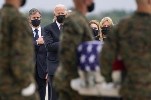 President Joe Biden, first lady Jill Biden, and Secretary of State Antony Blinken look on as as a carry team moves a transfer case with the remains of Marine Corps Cpl. Humberto A. Sanchez, 22, of Logansport, Ind., during a casualty return at Dover Air Force Base on Sunday for the 13 service members killed in the suicide bombing in Kabul on Aug. 26. (CAROLYN KASTER/Associated Press)